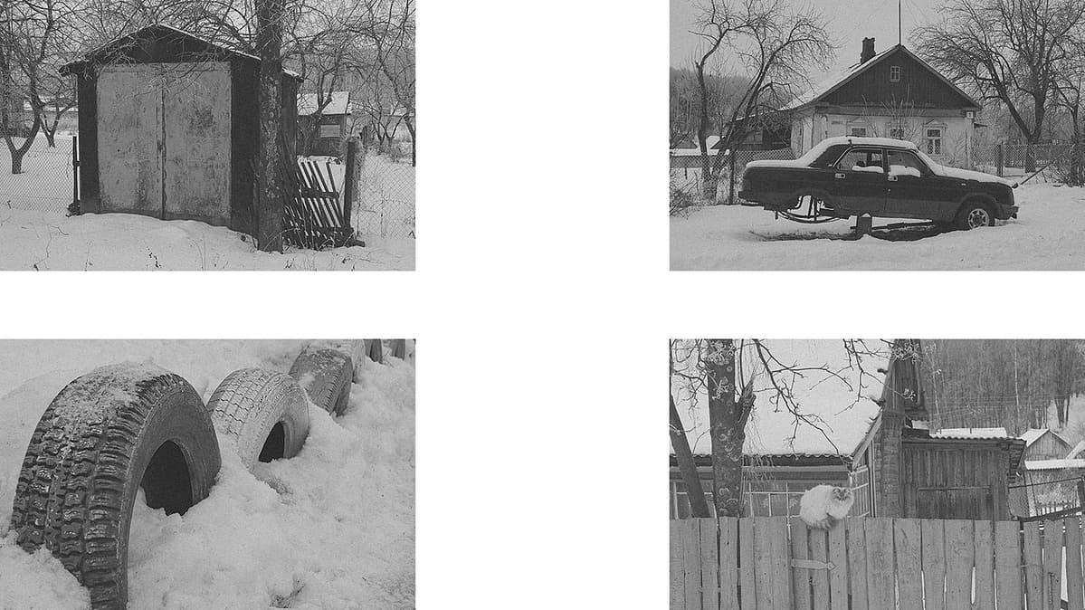 Top left: A private garage with the entrance covered by snow, indicating it is not used often.  Top right: A "Volga" (GAZ 3110) car covered in snow, with its rear wheels detached, standing on an improvised dais. An old village house is in the background.  Bottom left: Used truck tires dug into the ground, possibly for sitting or for children to play by jumping from one to another, now covered in snow.  Bottom right: A quiet, fluffy cat sitting on a wooden fence in front of an old village house.